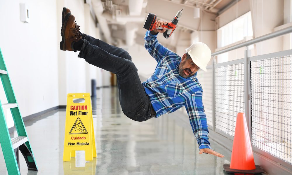 How to Minimize Workers' Comp Claims in Staffing Firms - Working man falling off a latter with a drill.